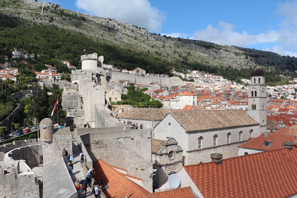 Dubrovnik city walls and Minčeta Tower with the Srđ hillside rising behind the Old Town