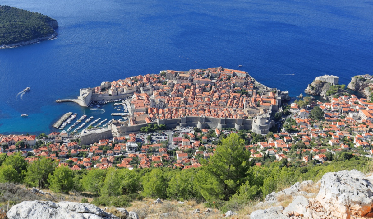 Dubrovnik Old Town and harbour seen from Mount Srđ, karst slope in the foreground